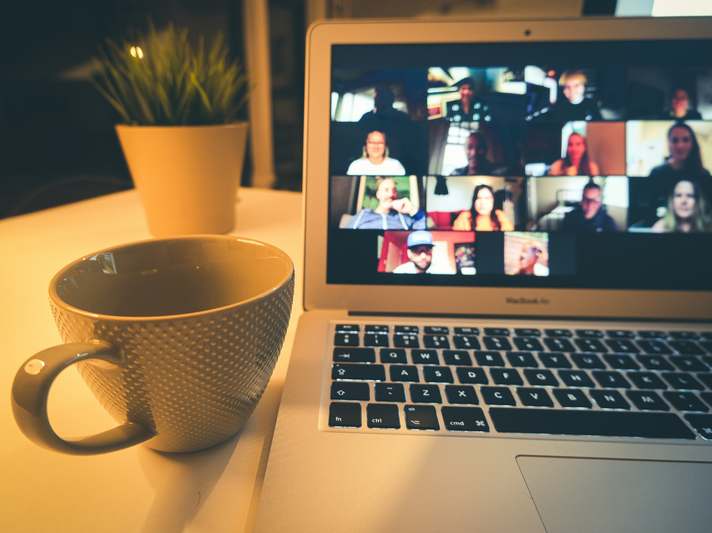 Two professionals smiling while discussing ideas over video call